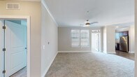 Located in Colorado Springs, CO, this single-floor residence presents a thoughtfully designed layout with a neutral color palette and quality finishes throughout. The open living area features plush carpeting, crown molding, and a ceiling fan with light fixture, creating a comfortable and airy atmosphere. Natural light filters in through blinds-equipped windows, and a door provides direct access to an outdoor space.

The kitchen is well-equipped with rich dark wood cabinetry, granite-style countertops, a subway tile backsplash, stainless steel appliances including a range and dishwasher, an undermount sink, and wood-look flooring — offering both functionality and visual appeal.

The primary bedroom is generously sized with carpeting, crown molding, a ceiling fan, and a walk-in closet. Its en-suite bathroom features a dual-sink vanity with dark wood cabinetry, granite countertops, wood-look flooring, framed mirrors, and a glass-enclosed shower. Additional bedrooms each include carpeting and closet storage. A secondary bathroom offers a tub-shower combination with a curved rod, dark cabinetry, and wood-look flooring, completing this well-appointed residence.