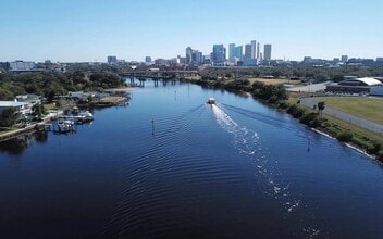 The river runs straight into downtown, with the Riverwalk following the bank. - Anchor Riverwalk