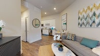 Located at 7108 E Lowry Blvd in Denver's Lowry neighborhood, this single-floor residence offers a well-designed open-concept layout that seamlessly connects the living, dining, and kitchen areas. The living room provides a welcoming atmosphere with warm wood-look flooring, elevated ceilings, and natural light streaming through large windows with blinds. The kitchen is outfitted with white shaker-style cabinetry, a classic white subway tile backsplash, stainless steel appliances including a range, microwave, and dishwasher, as well as ample counter space and a deep sink — ideal for everyday cooking and entertaining. A compact dining area sits adjacent to the kitchen, making efficient use of the open floor plan. The bedroom is a comfortable, well-lit retreat featuring wood-look flooring, a large window, and generous wall space. The bathroom includes a full soaking tub and shower combination with a curved curtain rod, white tile surround, neutral tile flooring, and crisp white cabinetry. Throughout the residence, a cohesive neutral color palette with clean white walls and warm flooring creates a bright, modern ambiance suited to a variety of lifestyles.