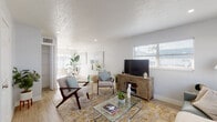 Located at 5320 NW 27th St in Lauderhill, Florida, this two-floor residence offers a clean, modern aesthetic throughout its thoughtfully designed interior. Light-toned wood-style flooring flows seamlessly across the main living areas, complementing the soft gray and white color palette that creates a bright, airy ambiance.

The living room is a welcoming space featuring a textured ceiling, recessed lighting, and multiple windows fitted with slatted blinds that allow natural light to filter in. The open layout connects the living area to a dining space, enhancing the sense of openness and flow.

The kitchen is a standout feature, showcasing slate-blue shaker-style cabinetry, granite countertops, a mosaic tile backsplash, and stainless steel appliances. A window above the sink provides natural light and ventilation, making it both functional and visually appealing.

The bedrooms are generously sized and well-lit, each offering windows with blinds, neutral wall tones, and wood-style flooring. One bedroom includes a louvered closet door, adding a classic touch to the room's design.

The bathrooms are clean and efficiently designed. One features a white vanity with chrome fixtures, a framed mirror, and a tub-shower combination, while a second bathroom presents a similarly fresh and tidy layout. Both maintain a cohesive, updated aesthetic consistent with the rest of the home.