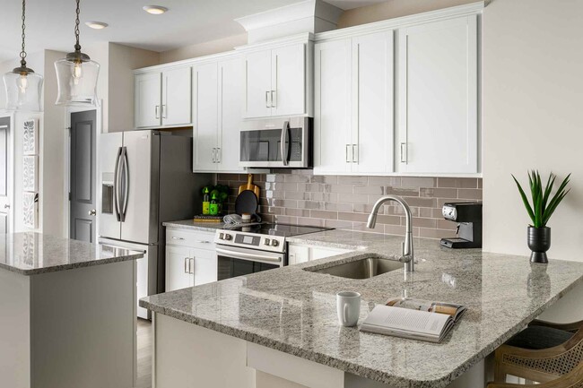 Designer kitchen with granite countertops, stainless Frigidaire appliances, under-cabinet lighting. - 1421 Lithium Ln