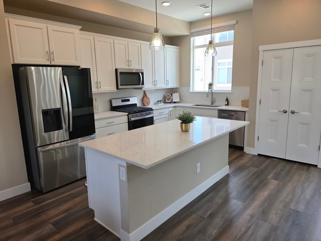 Open-concept kitchen with stainless steel appliances - 2220 S McIntyre St (Lakewood, CO)