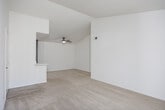 Located at 5636 Amaya Dr in La Mesa, CA, this well-appointed 2-bedroom, 2-bathroom residence offers a thoughtfully designed single-level layout. The open-concept living, dining, and kitchen area serves as the heart of the home, with plush carpeting underfoot and vaulted ceilings that lend a sense of spaciousness. A ceiling fan adds comfort to the living area, which flows directly onto a private balcony through a sliding glass door framed by vertical blinds, allowing for abundant natural light and outdoor views. The kitchen is outfitted with dark, modern cabinetry, white quartz countertops, light wood-style flooring, and a full suite of stainless steel appliances including a refrigerator, range, and microwave. Both bedrooms are carpeted and generously sized, each with access to a closet. The primary bedroom connects to its own bathroom, which features a modern vanity with dark cabinetry, a white quartz countertop, undermount sink, and brushed nickel fixtures. The second bathroom includes a full tub-shower combination with a curved curtain rod. An in-unit laundry area adds everyday convenience to this clean, move-in ready home.