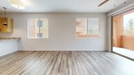 This well-appointed single-story unit in Los Alamos, New Mexico offers a thoughtfully designed layout across a comfortable footprint. The open-concept living room and kitchen area anchors the space, featuring durable wood-look plank flooring, a ceiling fan, and dual windows that draw in natural light while framing views of the colorful neighboring architecture and surrounding treeline. The kitchen is outfitted with modern light wood cabinetry extending to the ceiling, granite-style countertops, stainless steel appliances including a gas range with microwave, and a large French door refrigerator, offering generous storage and a clean, contemporary aesthetic.

The bedroom is carpeted for comfort, equipped with a ceiling fan, and features a window with views of the trees and mountains beyond. A dedicated closet provides practical storage. The bathroom includes wood-toned cabinetry, granite countertops, a full tub-shower combination, and wood-look plank flooring that ties the space together cohesively.

A separate laundry room houses a full-size washer and dryer, adding everyday convenience. Throughout the unit, the neutral color palette, consistent finishes, and abundant natural light create a clean, modern ambiance well-suited to the scenic New Mexico setting.