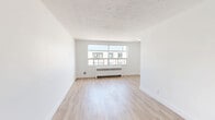 This well-appointed one-bedroom, one-bathroom unit is located at 318–352 Patricia Ave in Kitchener, Ontario, offering a thoughtfully designed layout across a single floor. The interior features light hardwood flooring throughout the living spaces, paired with crisp white walls that create a clean and airy atmosphere.

The living room is generously proportioned, benefiting from large windows that invite abundant natural light and offer views of the surrounding neighbourhood. Radiant baseboard heaters are positioned beneath the windows, providing efficient warmth throughout the colder months.

The kitchen is well-equipped with white cabinetry, grey stone-effect countertops, a stainless steel sink, and a classic white subway tile backsplash. Stainless steel appliances, including an electric range, microwave, and dishwasher, complete this functional cooking space.

The bedroom is a comfortable size, featuring a built-in closet with panel doors and direct access to the hallway. It also includes a large window that fills the room with natural light.

The bathroom continues the subway tile aesthetic seen in the kitchen, with floor-to-ceiling white tiles surrounding a full soaking tub and shower combination, accented by chrome fixtures for a polished finish.

A connecting hallway ties all areas together, contributing to the unit's efficient and practical flow.
