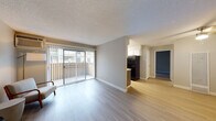 Located at 1600 Aster Dr in Antioch, California, this single-floor residence offers a practical and comfortable layout designed for everyday living. The open living area is finished with smooth laminate flooring and neutral gray walls, creating a bright and airy atmosphere. Large sliding glass doors flood the space with natural light and open to a private balcony, offering outdoor views. The galley-style kitchen is efficiently designed with white upper cabinetry, ample counter space, and black appliances including a gas range and a full-size refrigerator. A window at the end of the kitchen provides additional natural light. The bedroom features plush carpeting, a generous closet, and a window overlooking greenery, offering a quiet and restful retreat. A ceiling fan adds comfort to the additional living or flex space, which also benefits from laminate flooring. The full bathroom is clean and functional, appointed with a combination tub and shower, a vanity with a light countertop, and gray cabinetry. Textured ceilings are present throughout, and clean white trim and baseboards provide a polished finish across all rooms. The overall ambiance is calm, clean, and move-in ready.