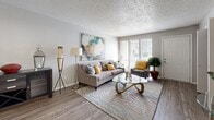 Located in Richardson, Texas, this single-floor, one-bedroom, one-bathroom residence offers a thoughtfully designed layout that maximizes its cozy footprint. Wood-look plank flooring flows throughout the main living areas, providing a cohesive and contemporary look.

The living room is bright and welcoming, benefiting from large sliding glass doors that invite natural light and offer an outdoor view. A textured ceiling adds character to the space. Adjacent to the living area, the dining room features a ceiling fan with light fixture and wainscoting detail along the lower wall, creating a defined and charming eating space.

The kitchen is well-equipped with white shaker-style cabinetry, speckled quartz countertops, stainless steel appliances including an electric range and dishwasher, and a double-basin sink with a flexible-neck faucet — delivering both style and function.

The bedroom is a comfortable retreat with plush carpet flooring, a textured ceiling, and a wide window that fills the room with natural light. A dedicated closet provides convenient storage. A hallway closet near the entryway adds additional storage capacity.

The bathroom features white cabinetry, quartz countertops, a large vanity mirror, and wood-look flooring, maintaining the modern aesthetic found throughout the home.