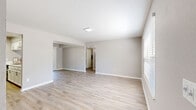 Located at 1421 SW 27th Ave in Ocala, Florida, this single-story, 4-bedroom, 1-bathroom home offers a clean and functional layout with a warm, neutral aesthetic throughout. Light-toned luxury vinyl plank flooring runs consistently across the home, complementing soft gray walls and crisp white trim to create a bright, cohesive interior.

The open living and dining area provides a comfortable sense of space, with natural light streaming in through large windows and a sliding glass door that leads to the patio. The kitchen features white cabinetry, a generous white countertop with a breakfast bar overhang, a stainless steel sink, and black appliances, including a range and refrigerator. A dedicated utility area houses the water heater and additional home systems.

Four well-proportioned bedrooms are distributed throughout the home, each finished with the same plank flooring and neutral paint. Several bedrooms include closets fitted with louvered bi-fold doors, offering practical storage. The spacious primary bedroom provides ample room for furnishings. A shared bathroom includes a vanity with a stone-finish countertop, a tub-shower combination, and modern fixtures. A dedicated laundry area and multiple hallway closets add to the home's overall functionality and storage capacity.