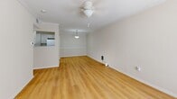 Located at 109 Charolais St in Lafayette, Louisiana, this single-floor, one-bedroom, one-bathroom home offers a efficient and well-organized layout. Light-toned wood-look flooring runs throughout the entire space, creating a cohesive and clean aesthetic. The living room is an open, airy area enhanced by crown molding, a ceiling fan, and a pass-through opening to the kitchen, allowing natural light to flow freely. A pendant light fixture adds a warm focal point between the two areas. The galley-style kitchen is thoughtfully designed with white cabinetry, ample counter space, a stainless steel sink, and full appliances including a refrigerator and dishwasher. A dedicated laundry area is conveniently integrated into the kitchen space. The bedroom is a comfortable, well-proportioned room featuring a ceiling fan, natural light from a window with blinds, and access to a closet. The bathroom is cleanly finished with gray cabinetry, a white vanity countertop, and a full tub-shower combination with white tile surround and brushed nickel fixtures. Throughout the home, neutral wall tones and white trim contribute to a bright, move-in-ready atmosphere.
