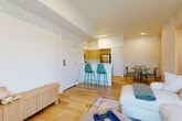 Located at 7000 NE 117th Ave in Vancouver, WA, this single-floor, 3-bedroom, 2-bathroom home offers a clean, modern aesthetic with thoughtful design details throughout. Light wood flooring flows seamlessly from the welcoming entryway through the living areas, creating a warm and cohesive feel.

The open-concept living area is bright and airy, featuring large windows and a sliding glass door that invite abundant natural light and outdoor views. The kitchen is efficiently designed with light wood cabinetry, white countertops, stainless steel appliances, and a breakfast bar with seating — ideal for both everyday meals and casual entertaining. A dedicated dining area sits adjacent to the kitchen.

The primary bedroom is a comfortable retreat, featuring plush carpet, a large window, and ample natural light. The two additional bedrooms are similarly appointed with carpet flooring and windows, offering versatile spaces for guests or a home office. The two bathrooms are clean and modern, with one featuring a glass-enclosed shower and a streamlined vanity with wood-toned cabinetry.

A connecting hallway leads to all bedrooms and bathrooms, with a dedicated closet providing additional storage. The overall ambiance of this home is light, neutral, and move-in ready, reflecting a contemporary style suited for comfortable everyday living.
