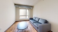 Located on the fourth floor at 309 Oak St SE in Minneapolis, this one-bedroom, one-bathroom unit offers a practical and well-designed layout across a single floor. The kitchen is a standout feature, outfitted with warm-toned wood cabinetry, granite-style countertops, stainless steel appliances including a refrigerator, range, microwave, and dishwasher, and a peninsula with bar seating illuminated by pendant lighting and track lights overhead. Hardwood flooring runs throughout the kitchen and living room, adding warmth to the space. The living room is compact yet functional, featuring a window that brings in natural light and views of the surrounding building exterior. The bedroom is carpeted and includes a window for additional light and ventilation, with exposed ductwork adding an industrial touch. A dedicated walk-in closet provides wire shelving overhead and built-in drawer storage below, offering organized storage capacity. The bathroom includes a wood-tone vanity with a stone-topped sink, tile flooring, open shelving, and a full-size soaking tub with shower. This unit combines modern fixtures with practical finishes throughout.