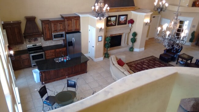 Looking down on the ground floor common room, with kitchen. - 661 S. 2220 W