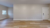 Located at 24279 W McGillen Ave in Mattawan, Michigan, this single-story, 2-bedroom, 1-bathroom home offers a clean, modern aesthetic with thoughtful finishes throughout. The open-concept living area seamlessly connects the living room, dining space, and kitchen, all united by warm-toned luxury vinyl plank flooring that enhances the bright, airy feel of the space. Neutral gray walls and white trim provide a crisp, contemporary backdrop throughout.

The kitchen is a standout feature, equipped with white shaker-style cabinetry, dark granite countertops, a classic subway tile backsplash, and a full suite of stainless steel appliances including a French door refrigerator, electric range, over-the-range microwave, and dishwasher. A window allows natural light to filter into the space.

Both bedrooms are comfortably sized and finished with neutral carpet, large windows that bring in outdoor views and natural light, and panel-style doors with dedicated closets. The bathroom features vinyl plank flooring, a tub/shower combo, and clean, simple finishes.

Additional practical features include an in-unit laundry area and a hallway connecting the main living spaces. The home presents a move-in-ready, well-maintained environment suited for comfortable everyday living.