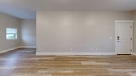 Located at 24279 W McGillen Ave in Mattawan, Michigan, this single-story, 2-bedroom, 1-bathroom home offers a clean, modern aesthetic with thoughtful finishes throughout. The open-concept living area seamlessly connects the living room, dining space, and kitchen, all united by warm-toned luxury vinyl plank flooring that enhances the bright, airy feel of the space. Neutral gray walls and white trim provide a crisp, contemporary backdrop throughout.

The kitchen is a standout feature, equipped with white shaker-style cabinetry, dark granite countertops, a classic subway tile backsplash, and a full suite of stainless steel appliances including a French door refrigerator, electric range, over-the-range microwave, and dishwasher. A window allows natural light to filter into the space.

Both bedrooms are comfortably sized and finished with neutral carpet, large windows that bring in outdoor views and natural light, and panel-style doors with dedicated closets. The bathroom features vinyl plank flooring, a tub/shower combo, and clean, simple finishes.

Additional practical features include an in-unit laundry area and a hallway connecting the main living spaces. The home presents a move-in-ready, well-maintained environment suited for comfortable everyday living.