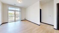 Located at 1235 Regent St in Madison, WI, this one-bedroom, one-bathroom unit offers a generously sized, single-floor layout with a clean, modern aesthetic. Light hardwood-style flooring and crisp white walls run throughout, creating a bright and cohesive atmosphere.

The kitchen is a standout feature, showcasing rich dark wood cabinetry, granite countertops, and a full suite of stainless steel appliances including a refrigerator, range, oven, and microwave. A central island with additional granite surface space adds both functionality and a natural gathering point, while pendant lighting above provides focused illumination.

The open living area receives abundant natural light through large sliding glass doors that lead to a private balcony with outdoor views of the surrounding Madison neighborhood. The bedroom is a well-proportioned retreat with a large multi-pane window that fills the space with daylight and neighborhood views, complemented by a dedicated closet for storage.

The bathroom features a walk-in shower with a sliding glass door, light flooring consistent with the rest of the unit, and a vanity with dark wood cabinetry. The entrance provides a practical transition into the main living area. Overall, the unit presents a contemporary, move-in-ready design with consistent finishes and thoughtful layout throughout.