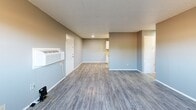 Located at 2704 NW 52nd St in Lawton, Oklahoma, this single-story, 2-bedroom, 1-bathroom home offers a practical and well-organized layout. Consistent wood-look luxury vinyl flooring runs throughout the entire home, complemented by cool gray wall tones and clean white trim for a cohesive, modern feel. Textured ceilings add character to each room.

The open living room provides a comfortable gathering space, with a wall-mounted HVAC unit and direct sightlines into the kitchen. The galley-style kitchen is efficiently designed with ample white cabinetry lining both sides, warm butcher block-style countertops, a double-basin sink, recessed lighting, and white appliances including a range and refrigerator.

Both bedrooms are well-proportioned and include ceiling fans with light fixtures. The primary bedroom features a window with outdoor views and generous closet space with bifold doors. The second bedroom also benefits from natural light via a window. Each bedroom offers a calm, neutral atmosphere suitable for comfortable living.

The single full bathroom includes a tub-shower combination, toilet, and vanity with countertop. Overall, the home presents a clean, functional interior that is practical for everyday living.