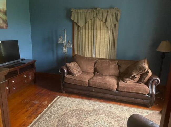 Bright living quarters, couch, chair and television is included - 2301 Hanover Rd