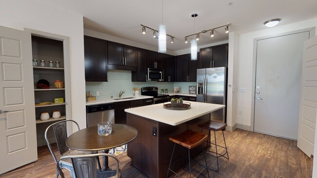 Large Kitchen with Stainless Steel Appliances - Eleven10 at Farmers Market Apartments