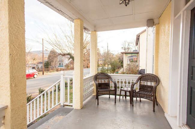 People watch on front porch - 205 Douglas Avenue