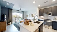 Located in Houston's vibrant Washington Avenue corridor, this 1-bedroom, 1-bathroom residence offers a thoughtfully designed open-concept layout. The combined kitchen and living area serves as the heart of the home, where dark navy cabinetry with a subway tile backsplash contrasts elegantly against a white quartz kitchen island with bar seating. Stainless steel appliances complete the modern kitchen. The living room flows seamlessly from the kitchen and opens directly onto a private balcony through large sliding glass doors, allowing abundant natural light and outdoor views to fill the space. A ceiling fan adds comfort to the living area. The bedroom is generously proportioned, featuring plush carpet, large windows framed by floor-to-ceiling drapes, and ample natural light with views of the surrounding neighborhood. A dedicated closet provides practical storage. The bathroom is clean and contemporary, featuring large-format tile flooring, a tub-shower combination with white subway tile surround, and a floating dark vanity with a white countertop. Light wood-tone flooring runs through the main living areas, tying the design together with a warm, cohesive aesthetic throughout.