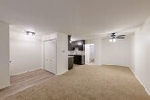 Located on Wildwood Street in Roseville, Michigan, this single-floor, one-bedroom, one-bathroom unit offers a practical and well-appointed layout. The combined living and dining area provides a generous open space anchored by neutral-toned carpet and a ceiling fan with light fixture. Baseboard heating runs throughout, ensuring year-round comfort. An entrance closet with arched bi-fold doors adds convenient storage upon entry.

The galley-style kitchen is a standout feature, showcasing rich dark espresso cabinetry with sleek hardware, granite-look countertops, a stainless steel sink, and a full suite of stainless steel appliances including a refrigerator, range, and over-the-range microwave. Light hardwood-style flooring and a pendant light fixture complete the kitchen's modern aesthetic.

The spacious primary bedroom features soft carpeting, a wall-mounted air conditioning unit, baseboard heat, and an elegant lantern-style ceiling fixture. Multiple closets throughout the unit provide ample storage. The bathroom is clean and functional, offering a full tub-shower combination with white tile surround, a vanity with storage, and hardwood-style flooring. The overall design presents a clean, updated, and move-in-ready living space.