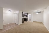 Located on Wildwood Street in Roseville, Michigan, this single-floor, one-bedroom, one-bathroom unit offers a practical and well-appointed layout. The combined living and dining area provides a generous open space anchored by neutral-toned carpet and a ceiling fan with light fixture. Baseboard heating runs throughout, ensuring year-round comfort. An entrance closet with arched bi-fold doors adds convenient storage upon entry.

The galley-style kitchen is a standout feature, showcasing rich dark espresso cabinetry with sleek hardware, granite-look countertops, a stainless steel sink, and a full suite of stainless steel appliances including a refrigerator, range, and over-the-range microwave. Light hardwood-style flooring and a pendant light fixture complete the kitchen's modern aesthetic.

The spacious primary bedroom features soft carpeting, a wall-mounted air conditioning unit, baseboard heat, and an elegant lantern-style ceiling fixture. Multiple closets throughout the unit provide ample storage. The bathroom is clean and functional, offering a full tub-shower combination with white tile surround, a vanity with storage, and hardwood-style flooring. The overall design presents a clean, updated, and move-in-ready living space.