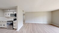 Located at 150 Continental St in Anderson, SC, this one-bedroom, one-bathroom unit offers a well-organized single-floor layout designed for comfortable everyday living. The living area is bright and open, featuring light-toned laminate flooring and a sliding glass door that fills the space with natural light while providing views of the surrounding greenery — a standout feature that connects the interior to the outdoors.

The galley-style kitchen is well-appointed with white cabinetry featuring matte black hardware, stainless steel appliances including a refrigerator, electric range, microwave, and dishwasher, complemented by white tile backsplash and light countertops. Light wood-look flooring carries through this space seamlessly.

The bedroom is a comfortable size, finished with plush wall-to-wall carpet, a ceiling fan with light fixture, a window for natural light and ventilation, and two doors — one leading to a closet and one to the hallway — providing practical storage and flow.

The bathroom is clean and functional, featuring a white vanity with mirror, a combined tub and shower with a curved curtain rod, and light wood-look flooring that ties the space together with a neutral, modern palette.

Rounding out the unit are a hallway connecting all rooms and a dedicated utility room, adding practical functionality to this efficiently designed home.