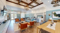 Located at 8575 Merchants Way in Jacksonville, FL, this one-bedroom, one-bathroom unit offers a well-designed single-floor layout that maximizes functionality. The open-concept living, dining, and kitchen area forms the heart of the home, featuring light wood-style flooring, recessed lighting, and a ceiling fan. The kitchen is outfitted with dark walnut-toned cabinetry, granite-style countertops, and a full suite of stainless steel appliances including a refrigerator, range, microwave, and dishwasher. Natural light flows into the living area through windows and a glass patio door, which opens to a private outdoor patio. The bedroom is carpeted for comfort, features a ceiling fan, a window with outdoor views, and connects to a spacious walk-in closet with built-in wire shelving. The bathroom includes a single-sink vanity with matching dark cabinetry, granite-style countertops, a large mirror, and a soaking tub. A dedicated in-unit laundry area adds everyday convenience. Throughout, the unit maintains a clean, modern aesthetic with neutral tones and consistent finishes.