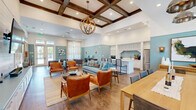 Located at 8575 Merchants Way in Jacksonville, FL, this one-bedroom, one-bathroom unit offers a well-designed single-floor layout that maximizes functionality. The open-concept living, dining, and kitchen area forms the heart of the home, featuring light wood-style flooring, recessed lighting, and a ceiling fan. The kitchen is outfitted with dark walnut-toned cabinetry, granite-style countertops, and a full suite of stainless steel appliances including a refrigerator, range, microwave, and dishwasher. Natural light flows into the living area through windows and a glass patio door, which opens to a private outdoor patio. The bedroom is carpeted for comfort, features a ceiling fan, a window with outdoor views, and connects to a spacious walk-in closet with built-in wire shelving. The bathroom includes a single-sink vanity with matching dark cabinetry, granite-style countertops, a large mirror, and a soaking tub. A dedicated in-unit laundry area adds everyday convenience. Throughout, the unit maintains a clean, modern aesthetic with neutral tones and consistent finishes.