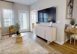 This contemporary 610 square foot apartment offers a well-designed living space that maximizes functionality and style. The open-concept layout seamlessly integrates the kitchen, living, and dining areas, creating a spacious feel despite the compact footprint. The kitchen boasts modern white cabinetry, stainless steel appliances, and a convenient breakfast bar with chic upholstered stools. A subway tile backsplash and quartz countertops add a touch of elegance.

The living room features wood-look flooring, large windows with stylish curtains, and a sleek entertainment unit. A comfortable white sofa and vibrant yellow accent chair provide ample seating. The 130 square foot bedroom is thoughtfully designed with a plush carpet, a statement upholstered headboard, and built-in closet space. Large windows allow natural light to flood the room.

The bathroom showcases a modern vanity, large mirror, and a combination tub/shower with sleek fixtures. Throughout the apartment, neutral tones are accented with pops of color in artwork and decor, creating a cohesive and inviting atmosphere. This well-appointed space in Winter Garden, FL, offers comfortable, stylish living in a compact yet efficiently designed layout.