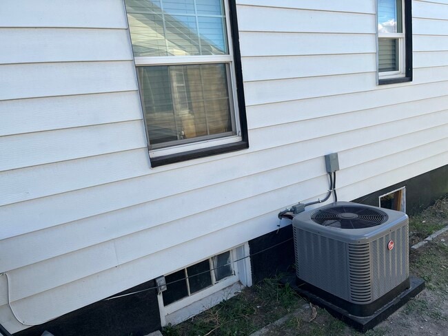 North side of house with new AC Unit - 1235 Ada Ave