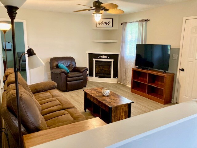 Fully furnished Living Room with 50" TV, DVD player, Gas fireplace, reclining couch and chair - 491 Grace Baptist Church Rd