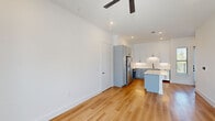 This two-story home in Garland, TX offers a thoughtfully designed layout across two floors, combining modern aesthetics with functional living spaces. The main floor is the heart of the home, featuring an open-concept living area and kitchen bathed in natural light from large front-facing windows and a glass-paneled entry door. Light hardwood flooring flows throughout the main level, complemented by recessed lighting and ceiling fans.

The kitchen is a standout feature, showcasing two-tone shaker cabinetry in soft gray and white, a white quartz island, subway tile backsplash, and a full suite of stainless steel appliances including a French door refrigerator, gas range, and built-in microwave. Ample counter and cabinet space make this a highly functional space.

Three bathrooms serve the home, including one featuring a soaking tub alongside a glass-enclosed walk-in shower with white subway tile and matte black hardware accents — a clean, contemporary design.

The bedrooms offer a comfortable retreat; the primary bedroom is generously sized, while the secondary bedroom features plush carpeting, a ceiling fan, and a bright window with outdoor views. Each bedroom includes closet space. The upper floor provides additional flexibility and privacy. Overall, the home presents a crisp, modern feel with quality finishes throughout.