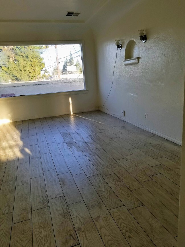 Living room with a lot of natural sunlight - 4110 2nd Ave