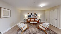 Located in Sevierville, Tennessee, this 2-bedroom, 2-bathroom residence offers a thoughtfully designed single-floor layout with a cohesive, modern aesthetic. Light wood-style flooring flows throughout, complementing the neutral warm-toned walls and crisp white trim found in every room.

The living room serves as the heart of the unit, offering a welcoming and well-proportioned space with warm ambient lighting and tasteful decor. The kitchen is equipped with dark espresso-toned cabinetry, stainless steel appliances including a refrigerator, range, microwave, and dishwasher, and a clean white countertop with a double sink — offering both style and functionality.

The primary bedroom is a comfortable retreat featuring a window with natural light, a closet, and soft neutral tones. The second bedroom mirrors this calm aesthetic with similar finishes and warm lighting. Both rooms provide a restful atmosphere suited for relaxing.

The two bathrooms are finished with dark wood vanities, white countertops, and light wood-style flooring. One bathroom features a shower-tub combination, while the other offers a streamlined vanity and toilet layout. A hallway connects the rooms, contributing to an efficient and functional floor plan. The overall ambiance is clean, modern, and inviting.
