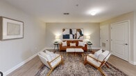 Located in Sevierville, Tennessee, this 2-bedroom, 2-bathroom residence offers a thoughtfully designed single-floor layout with a cohesive, modern aesthetic. Light wood-style flooring flows throughout, complementing the neutral warm-toned walls and crisp white trim found in every room.

The living room serves as the heart of the unit, offering a welcoming and well-proportioned space with warm ambient lighting and tasteful decor. The kitchen is equipped with dark espresso-toned cabinetry, stainless steel appliances including a refrigerator, range, microwave, and dishwasher, and a clean white countertop with a double sink — offering both style and functionality.

The primary bedroom is a comfortable retreat featuring a window with natural light, a closet, and soft neutral tones. The second bedroom mirrors this calm aesthetic with similar finishes and warm lighting. Both rooms provide a restful atmosphere suited for relaxing.

The two bathrooms are finished with dark wood vanities, white countertops, and light wood-style flooring. One bathroom features a shower-tub combination, while the other offers a streamlined vanity and toilet layout. A hallway connects the rooms, contributing to an efficient and functional floor plan. The overall ambiance is clean, modern, and inviting.