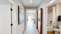 Located at 1755 Slaughter Rd in Huntsville, Alabama, this single-story 2-bedroom, 1-bathroom home offers a thoughtfully designed layout with contemporary finishes throughout. Light wood-look flooring flows seamlessly across every room, creating a cohesive and airy feel.

The welcoming hallway sets the tone with recessed lighting, neutral gray walls, and a large framed art piece, leading directly into the open-concept kitchen and living area. The kitchen is well-equipped with white shaker cabinetry, granite countertops, stainless steel appliances, and a central island with bar seating — ideal for both cooking and casual dining. The adjoining living room offers natural light through multiple windows and features a comfortable, stylishly curated space with room for seating and a wall-mounted TV.

The spacious primary bedroom includes a ceiling fan, large windows, and two closets — one of which is a walk-in with built-in shelving and hanging rods. The second bedroom features a warm terracotta accent wall and a ceiling fan, offering a cozy retreat with an outdoor view. The shared full bathroom includes a granite vanity and a tub/shower combination. Two dedicated closets provide ample storage throughout the home.
