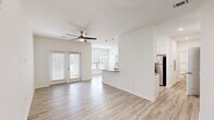 Located at 10293 Cassle Rd in Denham Springs, Louisiana, this single-story home offers a thoughtfully designed open-concept layout across a comfortable floor plan. Light wood-style flooring runs continuously throughout, complementing the crisp white walls and bright, airy atmosphere found in every room.

The kitchen is a standout feature, showcasing white shaker cabinetry, granite countertops, a subway tile backsplash, and a full suite of stainless steel appliances. A peninsula with pendant lighting provides additional counter space and connects seamlessly to the living area, where a ceiling fan and French doors invite natural light and outdoor access.

The bedroom is generously sized with a ceiling fan, a large window with outdoor views, and direct access to a dedicated closet. The bathroom is well-appointed with white cabinetry, granite countertops, a full soaking tub with a shower curtain rod, and matching wood-style flooring that ties the space together cohesively.

A hallway connects the main living areas to the private quarters, contributing to a logical and functional flow throughout the home. Clean lines, neutral tones, and modern fixtures define the overall aesthetic, making this a move-in ready home with contemporary appeal.