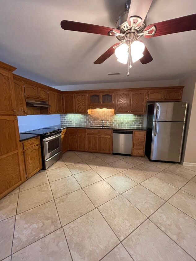 Kitchen features SS appliances. tile backsplash, cabinets & more cabinets hsshhh - 5133 County Road 73