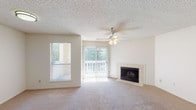 Located at 3801 Knollton Rd in Indianapolis, Indiana, this single-floor residence offers a well-organized layout with a variety of practical and comfortable features throughout. The spacious living room serves as the heart of the home, highlighted by a tile-surround fireplace, a ceiling fan with light fixture, and a textured ceiling. A sliding glass door floods the space with natural light and provides access to an outdoor area, complemented by a secondary window fitted with horizontal blinds. The neutral-toned carpet extends through the living and bedroom areas, creating a cohesive and warm feel. The kitchen is efficiently designed with warm wood cabinetry, white countertops, wood-look plank flooring, and black appliances including an electric range and a full-size refrigerator. A separate laundry closet is conveniently located just off the kitchen. The bedrooms are bright and well-proportioned, each with large windows that invite natural light and views of the surrounding greenery. The bathroom features a warm wood vanity with a mirror and overhead lighting, a bathtub and shower combination, and matching wood-look flooring that ties in with the rest of the home. Closet space is thoughtfully incorporated throughout, including a sizable closet adjacent to the bathroom.