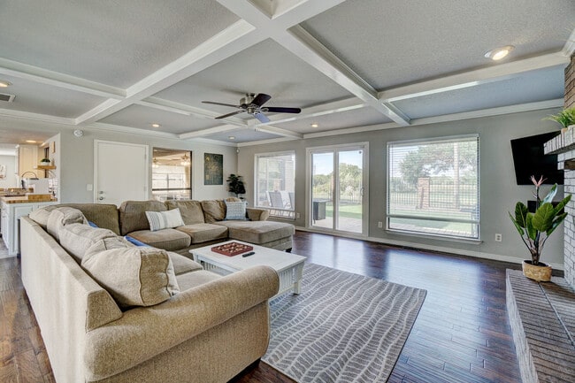 Relax and unwind in the spacious living room (equipped with a 58" Smart TV). - 3905 NW 70th St