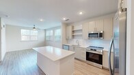 Located at 2720 Bristlecone Trail in Raleigh, NC, this thoughtfully designed one-bedroom, one-bathroom residence offers a clean, modern aesthetic across a single floor. Light wood-tone flooring runs throughout, complementing the bright white walls and recessed lighting that create a fresh, airy atmosphere.

The open-concept kitchen serves as the centerpiece of the living area, featuring two-tone cabinetry, a white subway tile backsplash, stainless steel appliances including a range, microwave, dishwasher, and refrigerator, along with a white quartz center island ideal for dining or meal prep. The kitchen flows seamlessly into the living area, which is brightened by multiple windows and a ceiling fan.

The hallway leading to the bedroom includes louvered closet doors that provide convenient storage access. The bedroom is a comfortable, well-lit space with multiple windows dressed in blinds, warm wood flooring, and a ceiling fan.

The bathroom is clean and functional, offering a tiled soaking tub and shower combination, a modern vanity with white countertop and under-cabinet storage, and wood-look flooring. A dedicated walk-in closet adjacent to the bedroom provides ample storage with multi-tiered wire shelving. This residence combines practicality and modern design in a cohesive, move-in-ready layout.