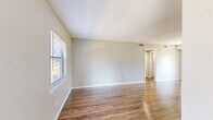 Located at 6440 62nd Ave N in Saint Petersburg, FL, this single-floor, 2-bedroom, 2-bathroom residence offers a practical and well-organized layout. The open-concept living, dining, and kitchen area forms the heart of the home, featuring warm wood-look flooring that runs throughout and a textured ceiling. The kitchen includes white cabinetry, a peninsula with a breakfast bar, and standard appliances, while a sliding glass door fills the space with natural light and provides outdoor access. The two bedrooms are comfortably sized, each with windows fitted with blinds that allow for natural light and views of the surrounding greenery. The primary bedroom includes a walk-in closet with wire shelving for organized storage. Three additional closets are distributed throughout the unit, providing ample storage. Both bathrooms are finished consistently, featuring tub-shower combos, white vanities with single-basin sinks, brushed nickel fixtures, and windows for ventilation. A dedicated utility room and a connecting hallway complete the layout. The neutral color palette, clean finishes, and cohesive flooring throughout give the space a fresh, move-in-ready feel.
