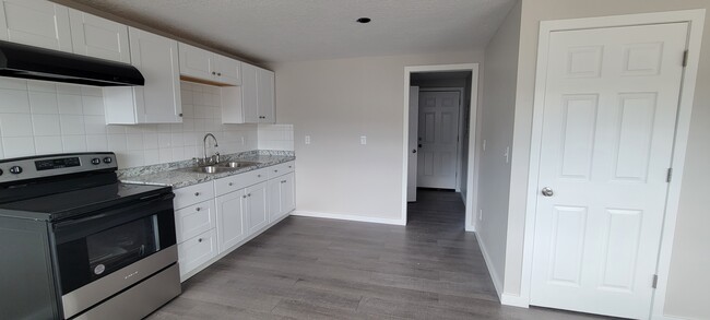 Kitchen leading to the hallway with bedroom the bedroom to the right and bathroom to the left - 254 E 500 N