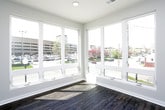 This single-floor unit is thoughtfully designed with a clean, contemporary aesthetic throughout. The open living area is bathed in natural light from large windows that offer outdoor views, and is finished with rich, dark hardwood-style flooring and recessed lighting, creating a bright and welcoming atmosphere.

The kitchen is well-appointed with white shaker-style cabinetry, granite countertops, and a full suite of stainless steel appliances, including a refrigerator, electric range, built-in microwave, and dishwasher. The layout provides ample counter and storage space, making it both functional and visually appealing.

The bedrooms feature plush carpet flooring, ceiling fans, and open closets with hanging rods for organized storage. Natural light enters through windows, and each room connects conveniently to the rest of the unit.

The bathrooms maintain the same consistent design language, with white shaker vanities topped with granite countertops, wood-style flooring, and full tub-shower combinations with clean white surrounds. Panel-style doors are used throughout, contributing to the unit's cohesive and modern finish.