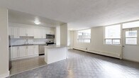 This well-appointed two-bedroom, one-bathroom unit at 2292 Weston Road in Toronto offers a thoughtfully laid-out single-floor residence. The spacious living room is a standout feature, filled with natural light from large windows and finished with distinctive checkered patterned flooring that extends throughout the unit. Baseboard heating is present in the living areas and bedrooms, ensuring comfortable year-round living.

The kitchen has been tastefully renovated, showcasing crisp white shaker cabinetry, granite-style countertops, a classic subway tile backsplash, and a full suite of stainless steel appliances including a refrigerator, stove, built-in microwave, and dishwasher. Light ceramic tile flooring completes the clean, modern aesthetic of this space.

Both bedrooms are bright and well-sized, each featuring windows with exterior views and the same checkered flooring found throughout. The primary bedroom offers a comfortable footprint, while the second bedroom includes a built-in closet with sliding doors for added storage convenience.

The bathroom is finished with floor-to-ceiling white subway tile surrounding a soaking tub, paired with clean white fixtures for a crisp, updated look. Overall, this unit presents a bright, functional, and modernly refreshed living space in the Weston neighbourhood of Toronto.