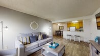 Located on Calle Verde in La Mesa, California, this single-floor residence offers a well-designed layout that balances comfort and functionality. Wood-look flooring flows consistently throughout the space, complemented by textured ceilings that add character to every room.

The open-concept living area serves as the heart of the home, providing a generous and welcoming space for relaxing and entertaining. A sliding glass door fills the room with natural light and opens directly to a private outdoor patio, ideal for enjoying Southern California's climate. The living area connects seamlessly to a dedicated dining space, which features a ceiling fan overhead.

The kitchen is efficiently designed with warm yellow wood cabinetry, ample counter space, and a peninsula breakfast bar with seating — perfect for casual meals. Full-size appliances complete the functional setup.

The bedroom is a peaceful retreat, featuring windows that invite natural light and mirrored sliding closet doors that enhance the sense of space. An adjacent bathroom offers a wide vanity with generous counter space and a shower-tub combination.

Additional highlights include a walk-in closet area and a layout that maximizes every square foot. The overall aesthetic is clean and neutral, offering a versatile canvas for personalizing the space.