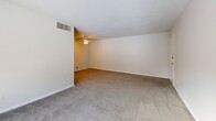 Located at 1925 Lawrence Rd in Havertown, PA, this two-bedroom, one-bathroom residence offers a functional and comfortable single-floor layout. The living room is generously proportioned, featuring soft carpeting, a ceiling fan, a textured ceiling, and a sliding glass door that opens to a private balcony, allowing natural light to fill the space. The kitchen is efficiently designed with warm oak cabinetry, granite-look countertops, hardwood flooring, a gas range, and a window that brightens the workspace. The spacious primary bedroom is a standout feature, offering room for generous furnishings, dual closets with louvered doors, a ceiling fan with light fixture, and neutral carpeting. The second bedroom is equally well-appointed with plush carpet, a ceiling fan, a closet, and a window that invites natural light. The full bathroom is finished with beige tile surrounding a full soaking tub and shower combination, tile flooring, a white vanity with built-in shelving, and a small window for ventilation. Throughout the residence, a neutral color palette and consistent finishes create a clean, cohesive ambiance well-suited for comfortable everyday living.