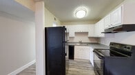 Located at 5422 N Nevada Ave in Colorado Springs, Colorado, this single-floor residence offers three bedrooms and two bathrooms within a practical and well-organized layout. The living room features durable hardwood-style flooring, neutral-toned walls, and a sliding glass door dressed with vertical blinds that fills the space with natural light while providing outdoor access. The textured ceiling carries throughout the home, adding a consistent design element. The kitchen is efficiently arranged in an L-shaped configuration, equipped with white cabinetry, dark granite-style countertops, and black appliances including a refrigerator, electric range, and dishwasher, all set atop matching hardwood-style flooring. The three bedrooms are carpeted for comfort, with neutral walls and windows that invite natural light. Ceiling fans are present in the bedrooms, enhancing airflow and comfort. The bathrooms are cleanly finished with white cabinetry, granite-style countertops, wood-look flooring, and a tub-shower combination. Additional storage is provided through a dedicated closet. The entrance leads seamlessly into the main living areas, creating a cohesive and functional flow throughout the home.