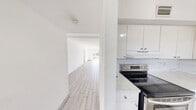 Located at 3800 Van Buren St in Hollywood, FL, this single-floor 2-bedroom, 2-bathroom residence offers a bright and clean living environment with a cohesive, modern aesthetic throughout. Light-toned wood-look tile flooring extends seamlessly across the living areas, hallways, and bedrooms, creating a uniform and easy-to-maintain interior.

The open living room is generously sized, bathed in natural light, and leads to a balcony with outdoor views — ideal for relaxing or entertaining. The kitchen is well-appointed with white cabinetry, marble-style countertops and backsplash, and stainless steel appliances including an electric range and refrigerator, complemented by a dishwasher and ample upper cabinet storage.

The primary bedroom is spacious and bright, featuring a large window with vertical blinds and a closet with louvered doors. The second bedroom also features a closet and receives natural light. Both bathrooms are finished in a clean, white palette with marble-look countertops, white vanity cabinets, and tiled walls. The hallways connect each room efficiently, contributing to a functional and well-organized floor plan. Overall, the space presents a fresh, move-in ready environment with a bright and airy ambiance throughout.